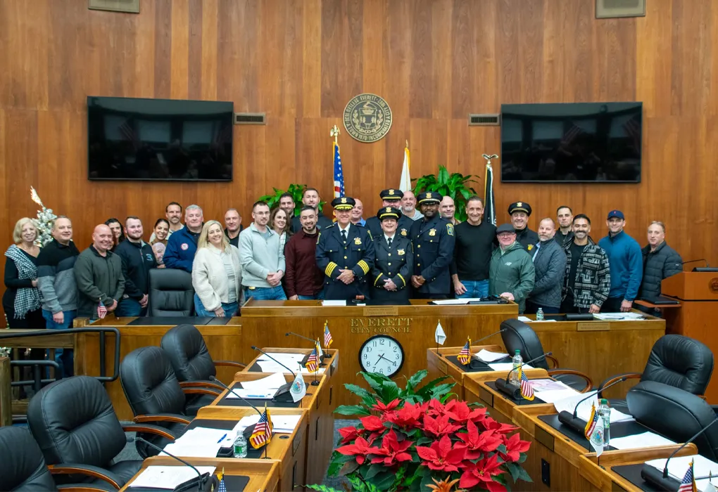 Police officers and community members in council chamber